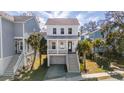 Attractive two-story home featuring a charming covered porch and a beautifully landscaped yard with palm trees at 775 Forrest Dr, Charleston, SC 29492