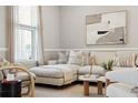 Bright living space featuring a comfortable sectional sofa, stylish throw pillows, and modern artwork at 822 Alma Square Dr, Moncks Corner, SC 29461