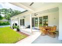 Relaxing covered patio featuring outdoor seating, ceiling fans, and a view of the lush backyard at 916 Kincade Dr, Mount Pleasant, SC 29464