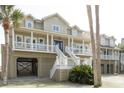 Beautiful coastal home featuring covered parking and a large porch, ideal for outdoor living at 10 Toms Turnaround Cir, Edisto Island, SC 29438