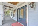 Close-up of a beautiful front door with decorative glass panels, sidelights, and stylish outdoor lighting fixtures on the porch at 1012 Denali Ct, Summerville, SC 29483