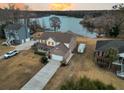 Aerial view of the beautiful home with a long driveway and lake access at 1106 Mccrae Dr, Moncks Corner, SC 29461