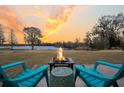 Outdoor fire pit with seating next to the lake at 1106 Mccrae Dr, Moncks Corner, SC 29461