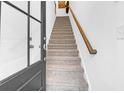 Bright entryway featuring a staircase with carpeted steps and a wooden handrail at 1241 Allusion Ln, Mount Pleasant, SC 29466