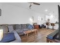 Open-concept living room featuring hardwood floors, a plush sectional couch, and a ceiling fan at 1241 Allusion Ln, Mount Pleasant, SC 29466