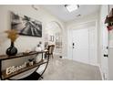 Inviting foyer featuring modern decor, arched doorway, light tile floors, and a front door with sidelights at 129 Isherwood Dr, Goose Creek, SC 29445