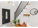 Bright foyer with coat hooks, a charming bench, and a stylish black front door at 1370 Little David Ct, Charleston, SC 29412