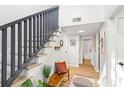 Inviting entryway featuring a staircase with modern railings and a cozy bench with decorative pillows at 1370 Little David Ct, Charleston, SC 29412