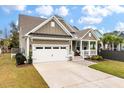 Inviting home with a two-car garage, covered front porch, and well-maintained landscaping at 1502 Checker Ct, Mount Pleasant, SC 29466