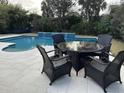 Outdoor patio features a table with 4 chairs overlooking the pool with a fountain feature at 1535 Watoga Way Way, Mount Pleasant, SC 29466