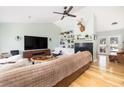 Bright living room featuring hardwood floors, a brick fireplace, and vaulted ceilings at 1649 Lauda Dr, Mount Pleasant, SC 29464