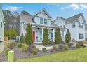 Delightful two-story home with a well-manicured landscape, bright red door, and light blue shutters at 1702 Sparkleberry Ln, Johns Island, SC 29455