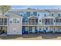 Rear view of the townhomes featuring screened-in porches and yard space at 196 Fair Sailing Rd # 25, Mount Pleasant, SC 29466
