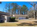 A detached three-car garage features a charming design and covered parking at 2015 Albert Storm Ave, Moncks Corner, SC 29461