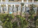 Aerial view of homes with fenced yards, driveways, and mature trees at 2025 Lanneau Ln, Johns Island, SC 29455