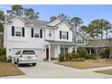 Charming two-story home boasts black shutters and a two-car garage at 2025 Lanneau Ln, Johns Island, SC 29455