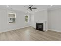 Bright living room boasts lots of natural light, a modern fireplace, and hardwood floors at 2205 Blue Bayou Blvd, Johns Island, SC 29455