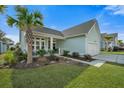 Attractive single Gathering home with a covered porch, tropical landscaping, and an attached one-car garage at 2379 Lenwick Hall Ln, Johns Island, SC 29455