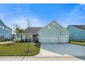 Inviting single Gathering home with a two-car garage, light blue exterior, and a neatly kept lawn at 2379 Lenwick Hall Ln, Johns Island, SC 29455