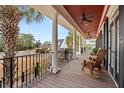 Covered front porch featuring columns, rocking chairs, and a ceiling fan for outdoor relaxation at 2786 Parkers Landing Rd, Mount Pleasant, SC 29466