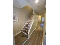 Inviting hallway with a staircase featuring wood-look floors and neutral paint, leading to other rooms at 2905 Sweetleaf Ln, Johns Island, SC 29455