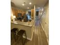 Open kitchen view with a breakfast bar, stainless steel appliances, and seamless connection to entry area at 2905 Sweetleaf Ln, Johns Island, SC 29455