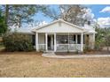 Inviting front porch with white rocking chairs, enhancing the curb appeal of this charming home at 3589 Walter Dr, Johns Island, SC 29455