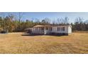 Spacious single-story home with a covered porch, a side carport and a expansive yard in a serene wooded setting at 516 & 508 Robnshers Pl, Ridgeville, SC 29472