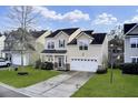 Inviting two-story home with a well-kept lawn, two-car garage, and charming entryway at 1052 Whitlow Blvd, Summerville, SC 29483