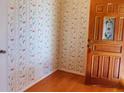 Entryway featuring decorative wallpaper, hardwood flooring, and wooden door with glass insert at 115 St Awdry St, Summerville, SC 29485