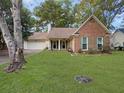 Charming brick home with a well-maintained lawn and a welcoming covered porch at 115 St Awdry St, Summerville, SC 29485