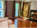 Comfortable living room with hardwood floors, cozy fireplace, and natural lighting at 115 St Awdry St, Summerville, SC 29485