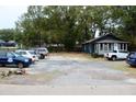 Gravel parking lot featuring several cars parked in front of a home at 2008 Cosgrove Ave, North Charleston, SC 29405