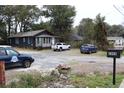 Street view featuring several cars parked in a gravel lot in front of a home and an address mailbox at 2008 Cosgrove Ave, North Charleston, SC 29405