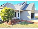 Single-story home with neutral siding, solar panels, manicured landscaping, and attached two-car garage at 236 Highwoods Plantation Ave, Summerville, SC 29485