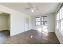 Bright, airy living room with wood floors, ceiling fan, and many windows at 2694 Olympia Ave, North Charleston, SC 29405