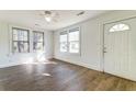 Bright, airy living room with wood floors, ceiling fan, and many windows at 2694 Olympia Ave, North Charleston, SC 29405