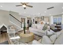Open-concept living room featuring modern furniture, a ceiling fan, and hardwood floors at 304 O'Malley Dr, Summerville, SC 29483