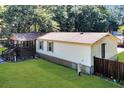 Backyard of home featuring a porch, a well-maintained lawn, and a wooden fence at 317 Lankford St, Moncks Corner, SC 29461