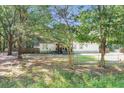 View of single-story home nestled in a verdant setting, enhanced by mature trees at 317 Lankford St, Moncks Corner, SC 29461