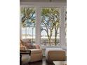 Bright living room seating area looking out of the large windows with an outside view at 32-E Prioleau St, Charleston, SC 29401