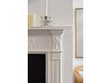 Close-up of a white fireplace mantel showcasing detailed molding and decorative accents at 35 Tradd St, Charleston, SC 29401