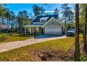 Lovely house with a long driveway and garage, surrounded by lush green lawns at 418 Myers Mayo Rd, Ridgeville, SC 29472