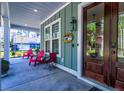 Inviting front porch with cozy seating, great for relaxing and enjoying the outdoors at 418 Myers Mayo Rd, Ridgeville, SC 29472
