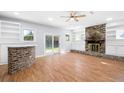 Cozy living room with a brick fireplace, built-in bookshelves, and sliding doors to the yard at 782 Bonham Dr, Charleston, SC 29412