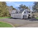 Spacious home with three-car garage, complemented by a circular driveway and well-maintained landscaping at 100 Oak Village Ln, Summerville, SC 29483