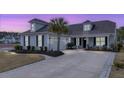Lovely home showcasing a well-manicured lawn, mature palm, and long driveway at 115 Bluff Isle Ct, Summerville, SC 29486