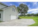 Spacious two-car garage with ample parking area and view of the serene lake at 1721 Pimlico Blvd, Moncks Corner, SC 29461