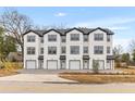 A modern townhouse complex is complete with garages, front lawns, and contemporary design at 2191 Helm Ave, North Charleston, SC 29405