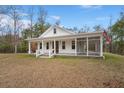 Charming single-story home boasts a white exterior, inviting front porch and screened in side porch at 5585 Wire Road, Branchville, SC 29432
